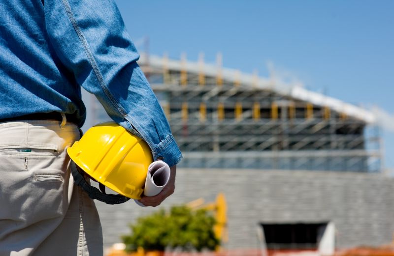 quantity-surveyor-hardhat-under-arm